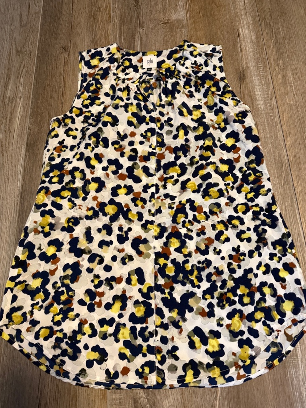 CAbi Fierce Seeing Spots sleeveless blouse featuring a colorful animal print - Picture 1 of 6